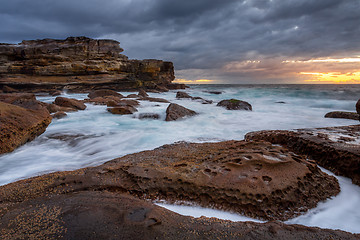 Image showing Potter Point sunrise and rock flows icliffs