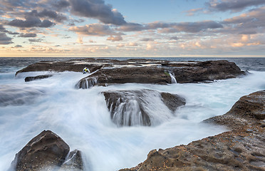 Image showing Stranded  Rock Fisherman almost taken by the ocean