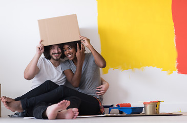 Image showing young multiethnic couple playing with cardboard boxes