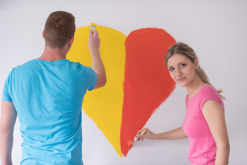 Image showing couple are painting a heart on the wall