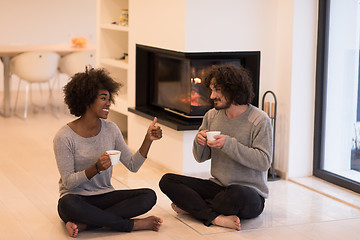 Image showing multiethnic couple  in front of fireplace