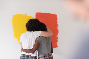 Image showing multiethnic couple painting interior wall