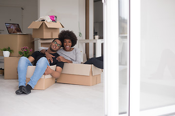 Image showing African American couple  playing with packing material