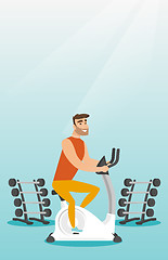 Image showing Young man riding stationary bicycle.