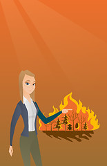 Image showing Woman standing on background of wildfire.