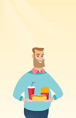 Image showing Man holding tray full of fast food.