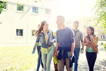 Image showing group of happy teenage students walking outdoors