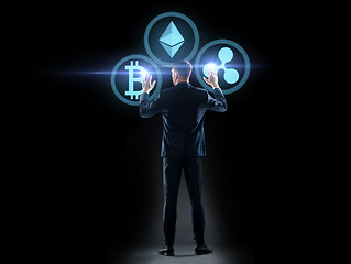 Image showing buisnessman with cryptocurrency holograms