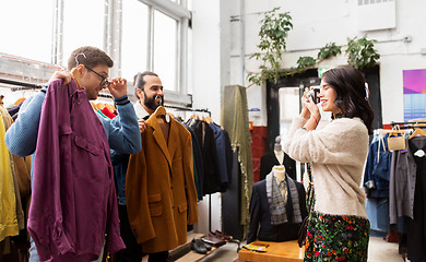 Image showing friends photographing at vintage clothing store