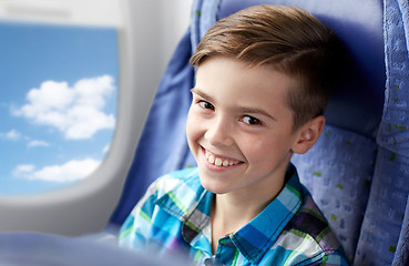 Image showing happy boy travelling by plane