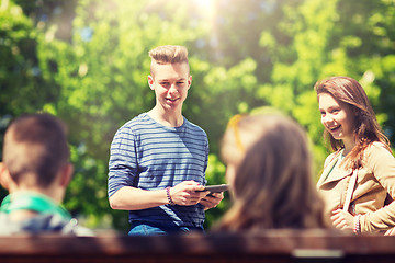 Image showing group of teenage students with tablet pc outoors