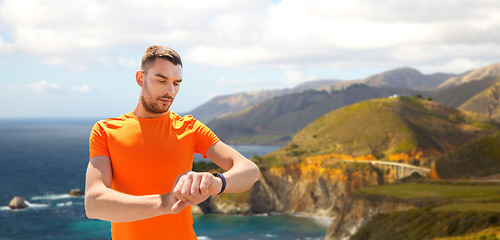 Image showing man with fitness tracker training outdoors