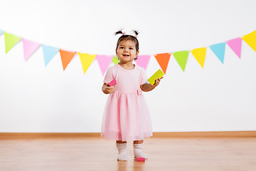 Image showing happy baby girl with toy blocks at birthday party