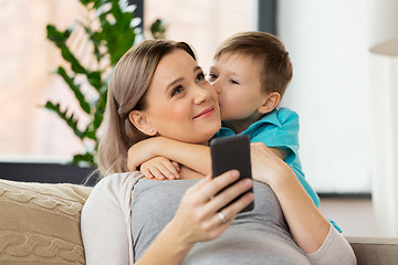 Image showing son kissing happy pregnant mother at home