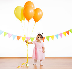 Image showing happy baby girl with balloons on birthday party