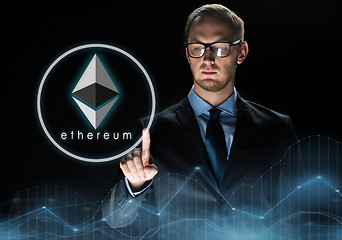 Image showing businessman with ethereum hologram over black