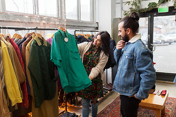 Image showing couple choosing clothes at vintage clothing store