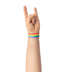 Image showing hand with gay pride rainbow wristband shows rock