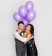 Image showing happy couple with ultra violet balloons at party