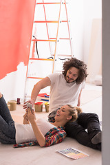 Image showing Happy young couple relaxing after painting