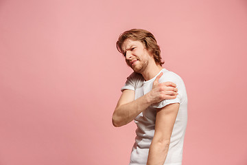 Image showing Young man overwhelmed with a pain in the stomach .