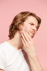 Image showing Young man is having toothache.