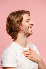 Image showing The young attractive man looking suprised isolated on pink