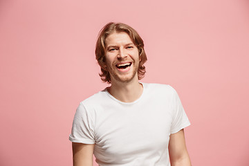 Image showing The happy business man standing and smiling against pink background.