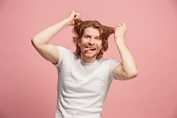 Image showing The squint eyed man with weird expression isolated on pink