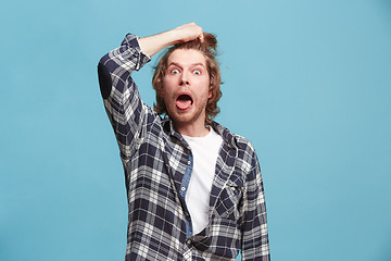 Image showing Young man in stress isolated on blue