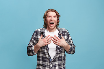 Image showing Beautiful man looking suprised isolated on blue