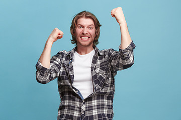 Image showing Winning success man happy ecstatic celebrating being a winner. Dynamic energetic image of male model