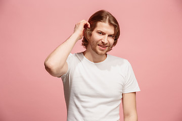 Image showing The happy business man standing and smiling against pink background.