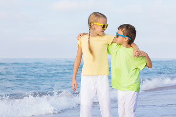 Image showing Two happy children playing on the beach at the day time