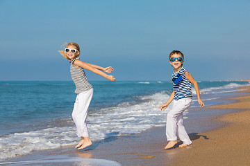 Image showing Two happy children playing on the beach at the day time