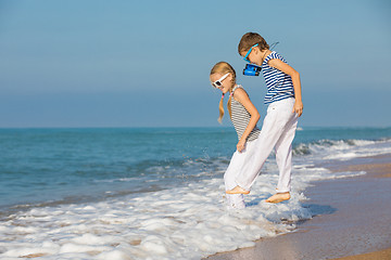 Image showing Two happy children playing on the beach at the day time