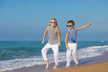 Image showing Two happy children playing on the beach at the day time