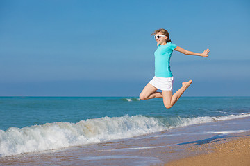 Image showing teen girl jumping on the beach at blue sea shore in summer vacat