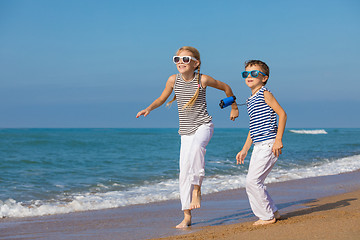 Image showing Two happy children playing on the beach at the day time