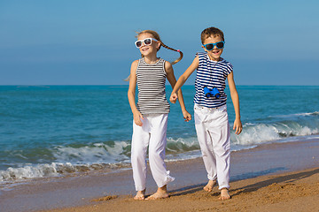 Image showing Two happy children playing on the beach at the day time