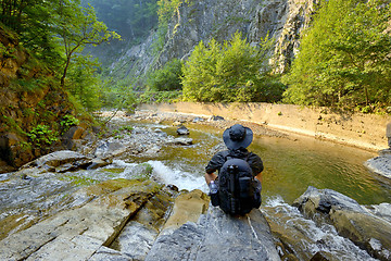 Image showing young man with  backpack enjoying  on  mountain