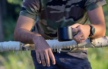 Image showing Man drinking coffee on fenced ranch