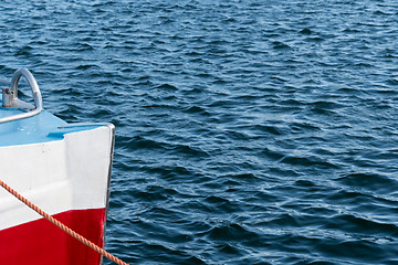 Image showing Colorful bow of a boat in rippled water