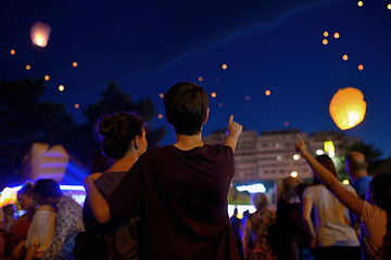 Image showing Teens in night watching paper lantern