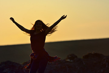 Image showing Teen girl jump against beautiful sunset