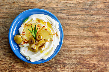 Image showing fresh cream cheese with olives and lemon