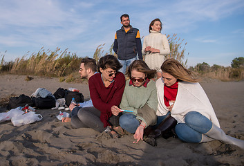 Image showing Friends having fun at beach on autumn day