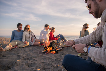 Image showing Friends having fun at beach on autumn day