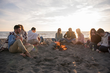 Image showing Friends having fun at beach on autumn day