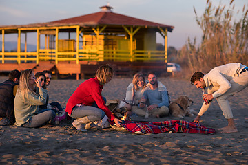 Image showing Friends having fun at beach on autumn day